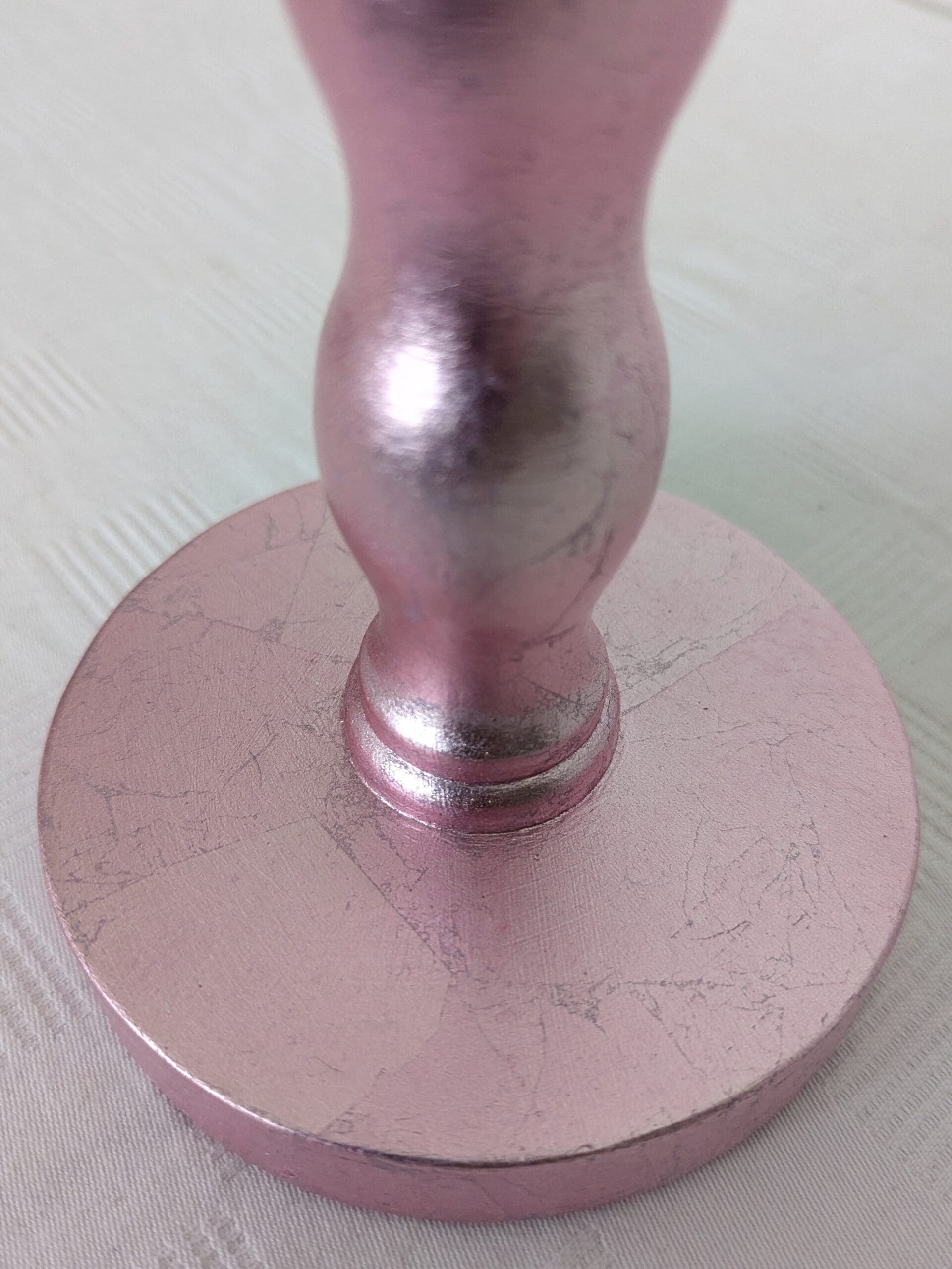 close up of base of pink cordless lamp made from reclaimed wavy chair leg