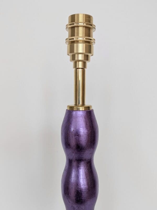 close up of purple gilded cordless lamp showing brass bulb holder for rechargeable bulb