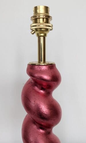close up of top of gilded barleytwist red cordless lamp showing brass bulb holder