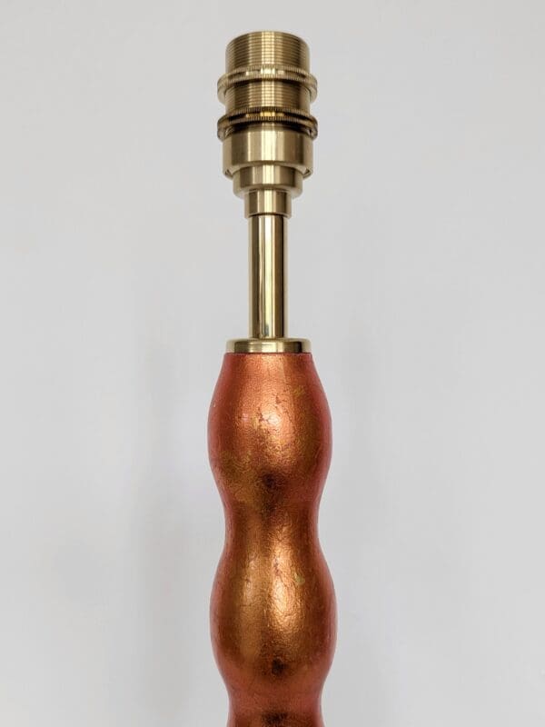 close up of bulb holder on orange wavy cordless lamp