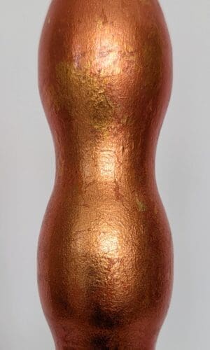 close up view of orange gilded wavy cordless lamp