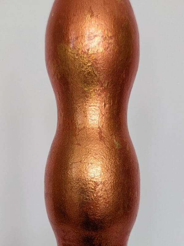 close up view of orange gilded wavy cordless lamp