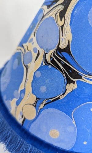 detail of handmade blue and gold marbled paper lampshade