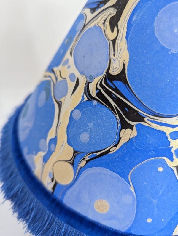 detail of handmade blue and gold marbled paper lampshade