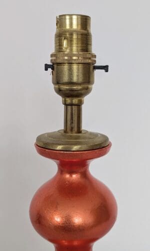 orange curvy lamp with brass bayonet bulb holder