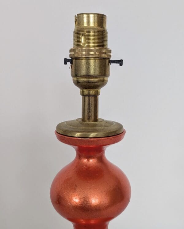 orange curvy lamp with brass bayonet bulb holder