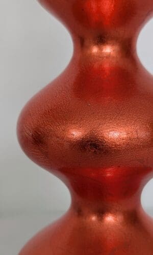 close up of orange curvy lamp showing the rich colour and texture of the orange dyed silver leaf finish