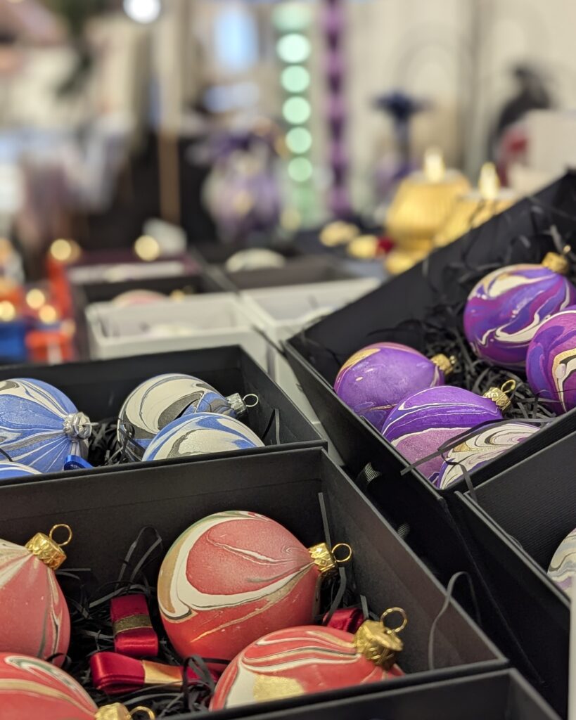 Display of marbled Christmas baubles at a craft fair