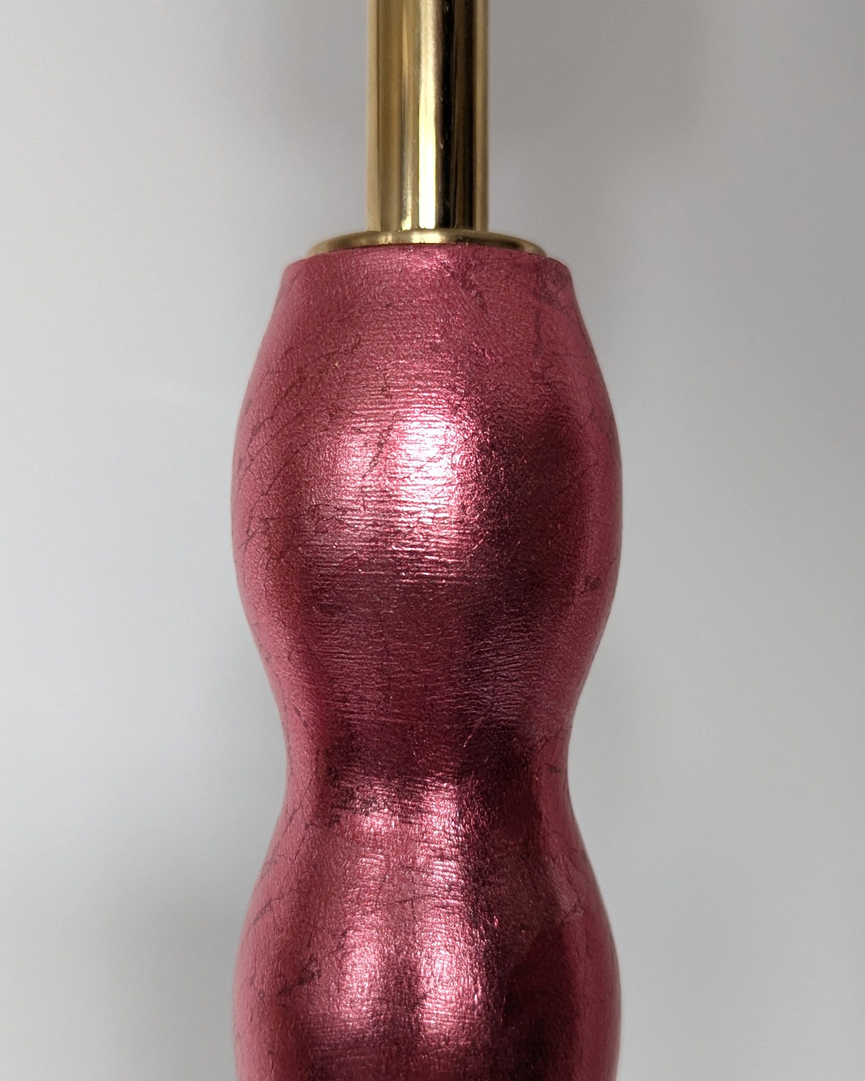 close up of lustrous red metallic finish with brass bulb holder
