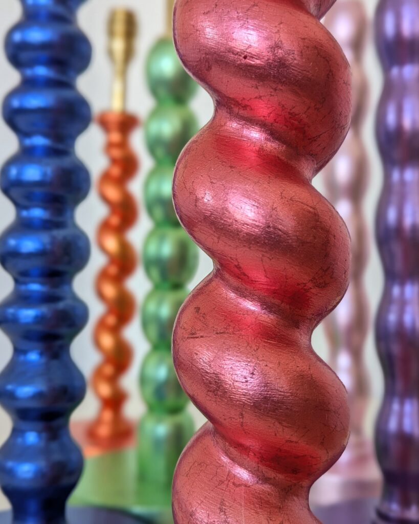 Twist and bobbin shaped pieces gilded in brightly coloured silver leaf