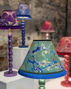 Colourful marbled paper lampshades on gilded cordless lamps