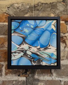 Turquoise marbled square artwork panel within black floating frame