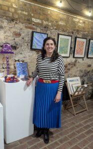 Carrie Webb standing with her work at Pie Factory Margate