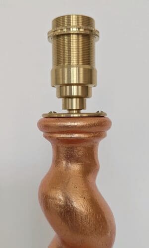Top of peach cordless lamp with brass bulb holder