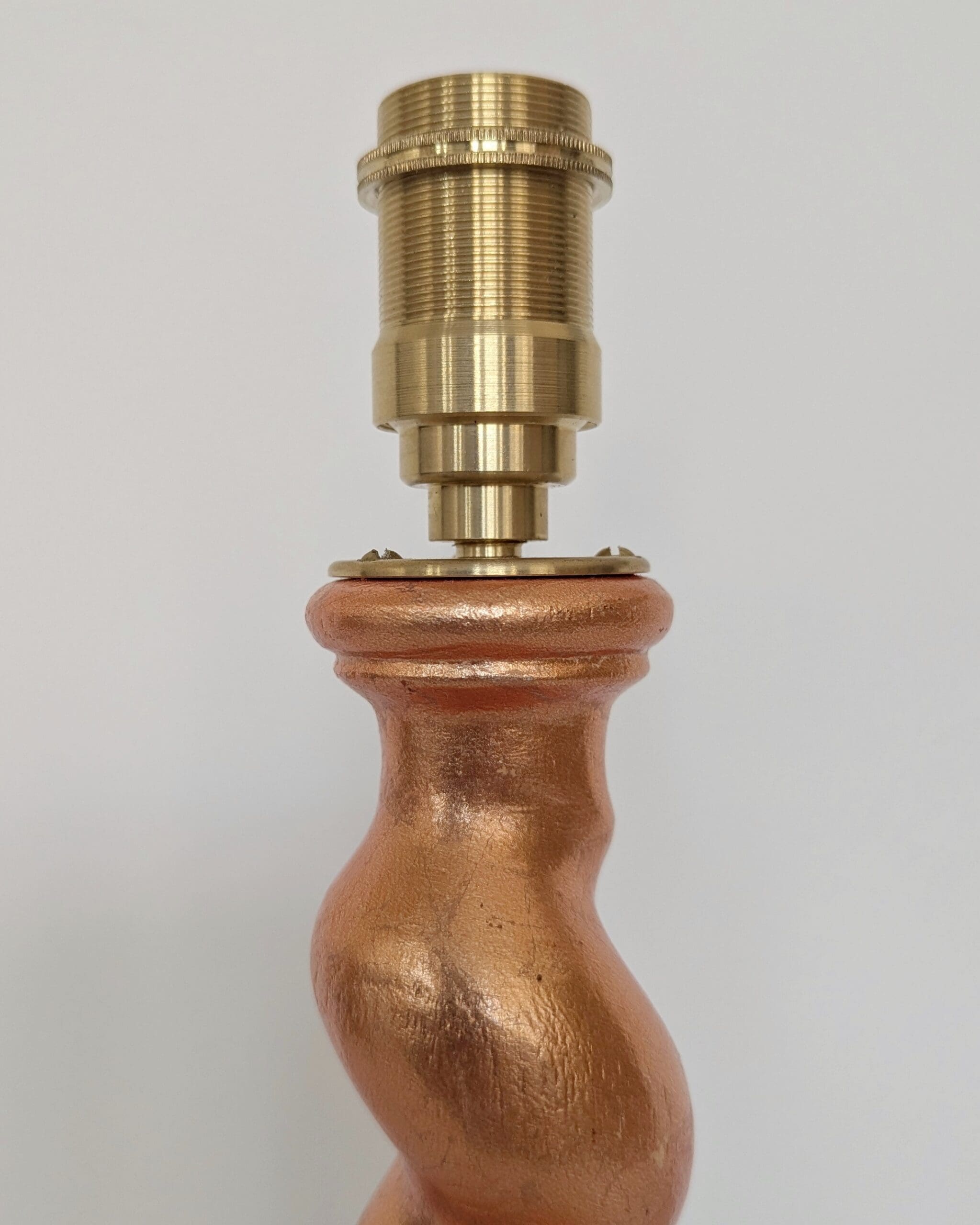 Top of peach cordless lamp with brass bulb holder