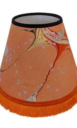 Peach marbled lampshade with orange fringing and velvet ribbon trim