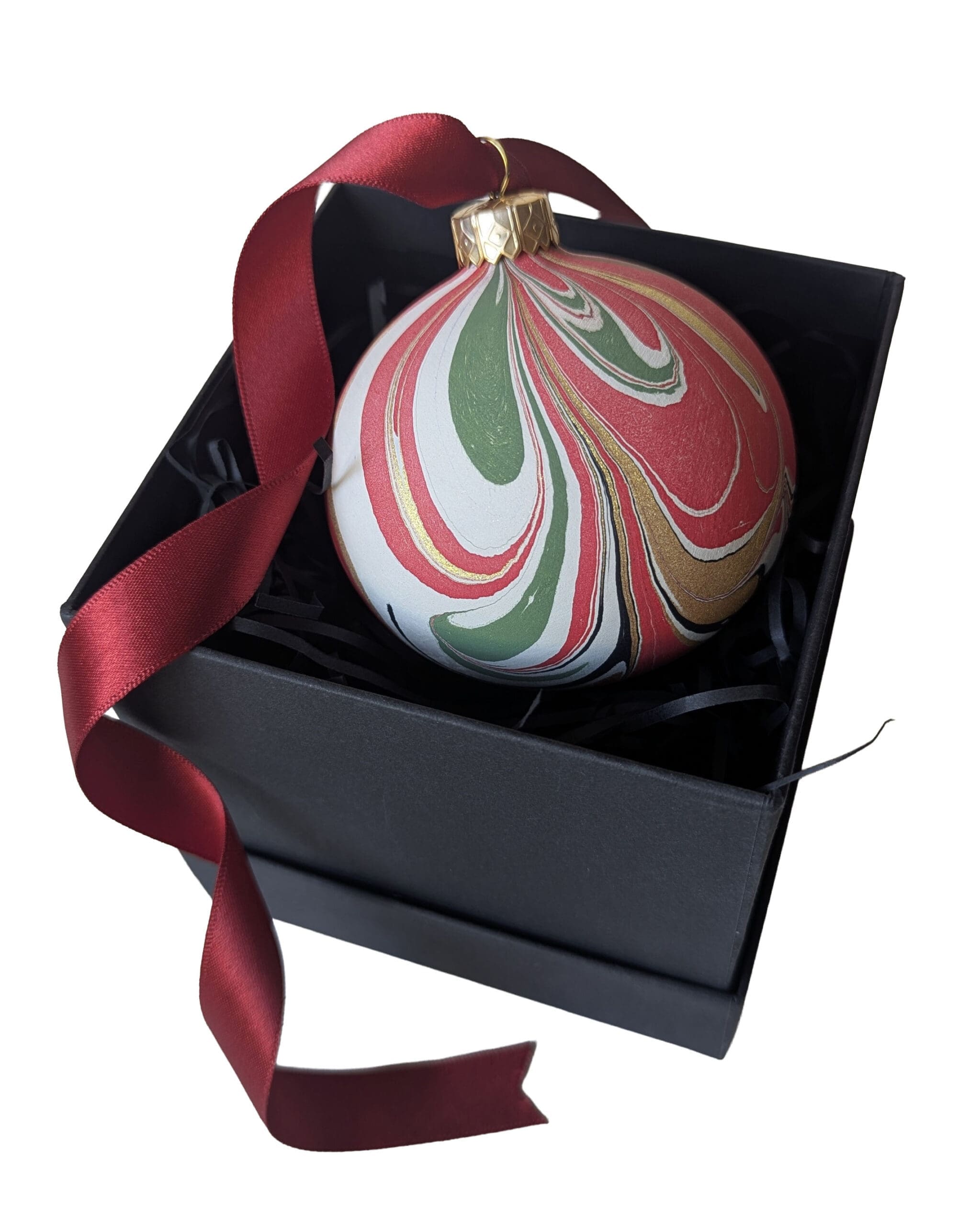 Red, green and gold marbled Christmas bauble with long red satin ribbon in black gift box