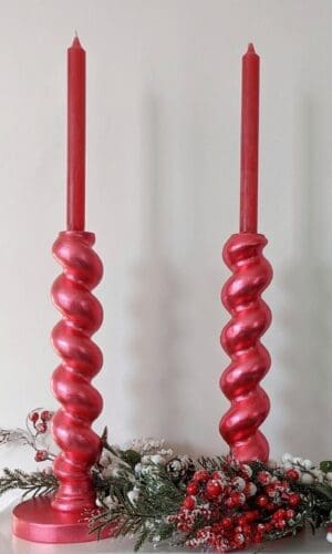 Metallic chunky, red candlesticks with red candles and snowy Christmas garland