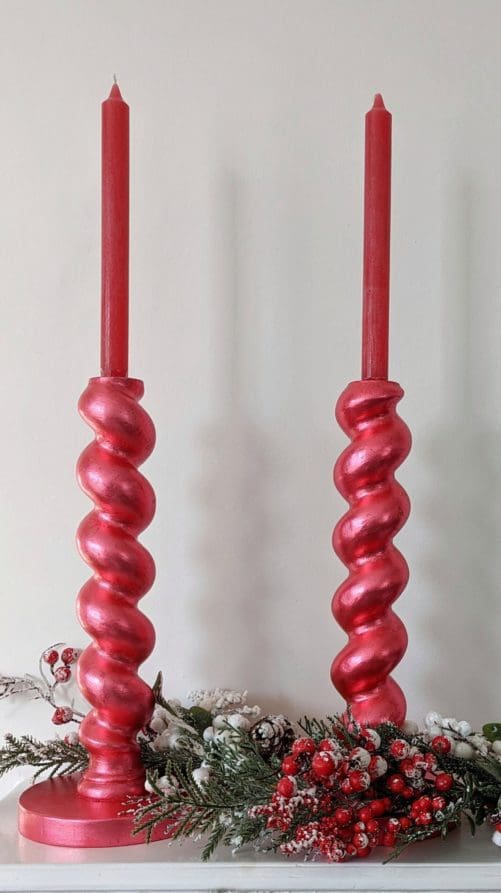Metallic chunky, barleytwist candlesticks with red candles and snowy Christmas garland