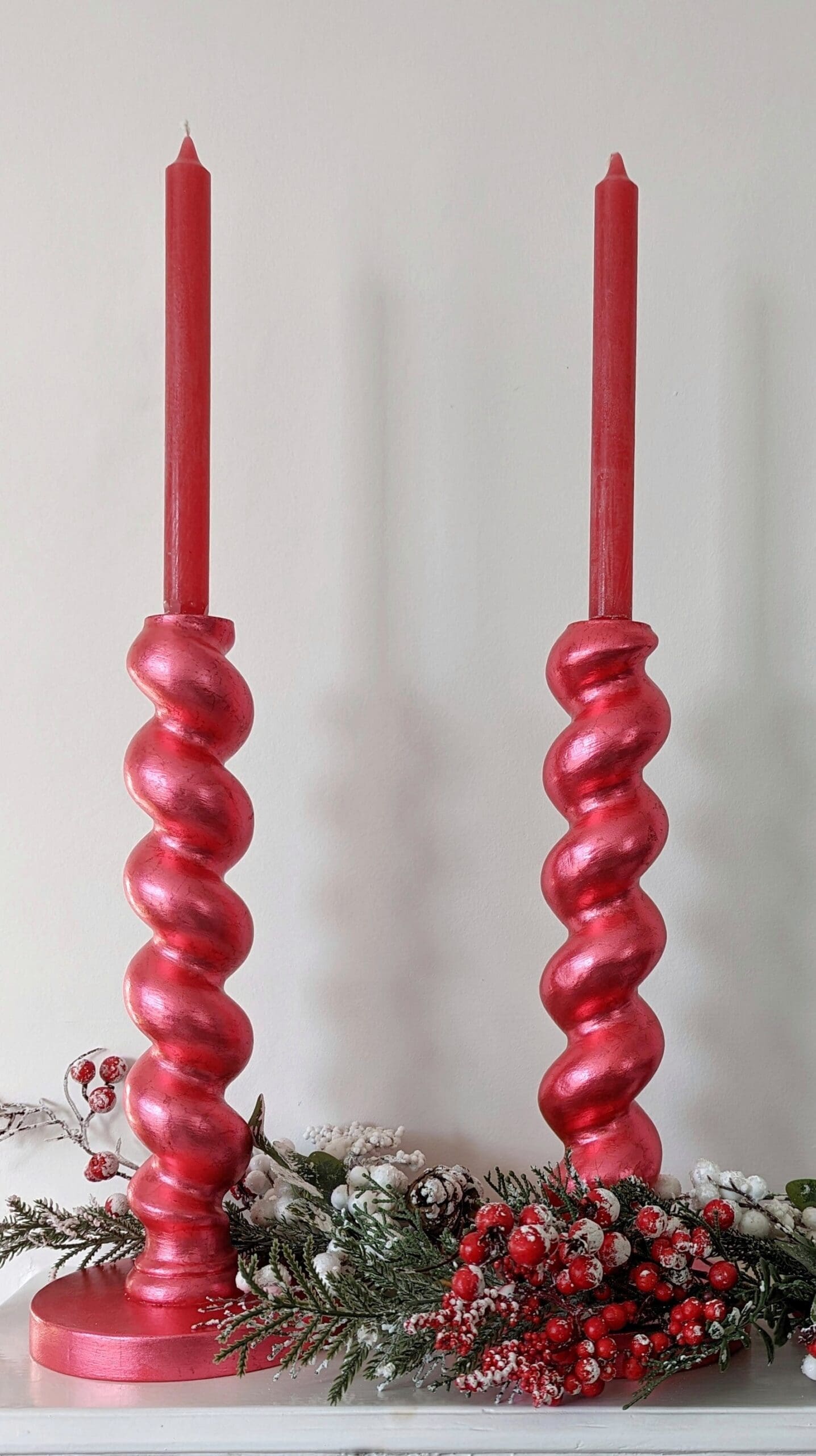 Metallic chunky, red candlesticks with red candles and snowy Christmas garland