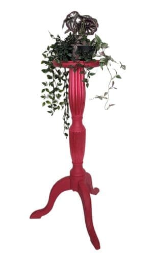 Tall red plant stand with trailing plants