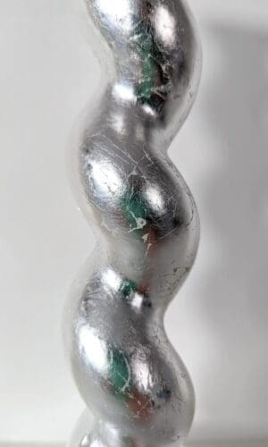 Close up of silver gilded barleytwist candlesticks showing soft metallic sheen and texture