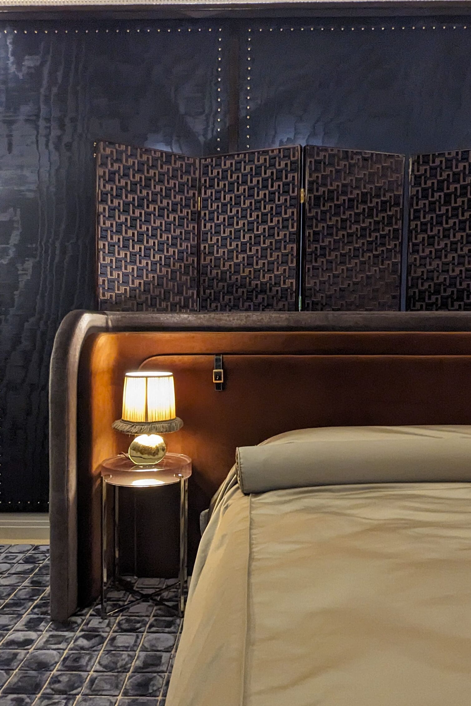 WOWhouse bedroom Navy silk walls with a bed in front of a brown curved headboard