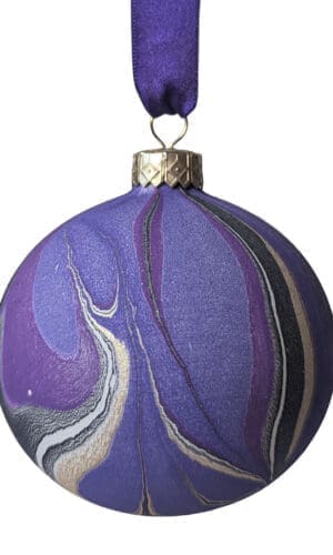 Purple, black and gold marbled Christmas bauble hanging on purple ribbon