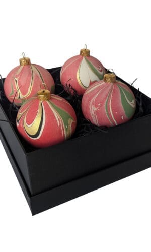 Box of red, green and gold marbled Christmas baubles in a square black gift box
