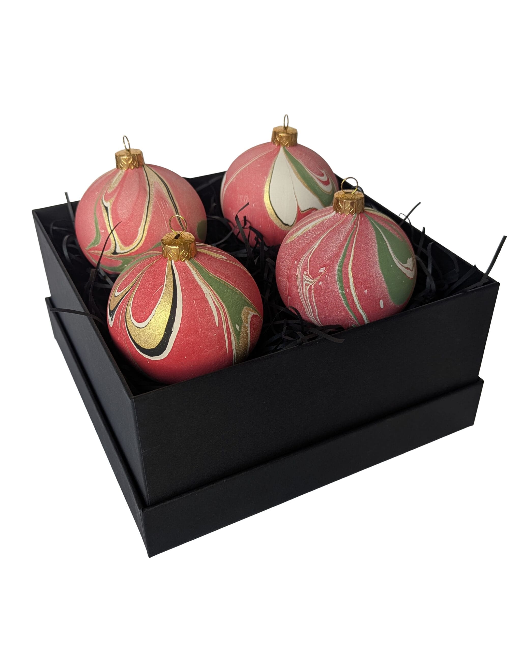 Box of red, green and gold marbled Christmas baubles in a square black gift box