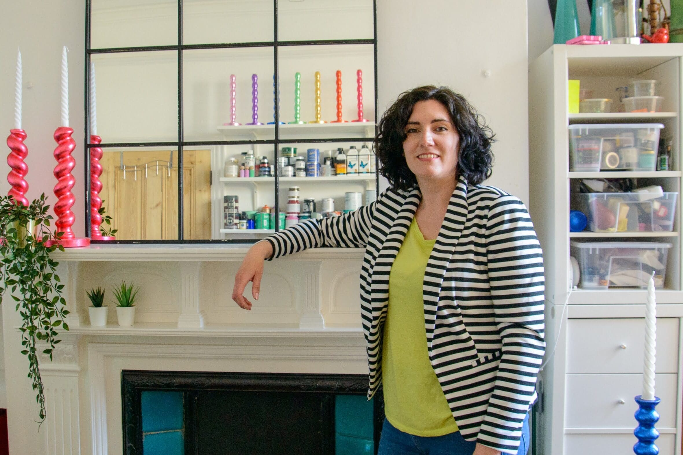 Carrie Webb resting her arm on the mantlepiece of her Margate studio