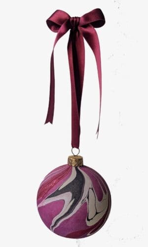 marbled christmas bauble in cherry red, plum, black and gold hanging on dark red satin ribbin with bow