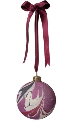 marbled christmas bauble in cherry red, plum, black and gold hanging on dark red satin ribbin with bow