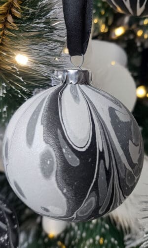Monochrome marbled Christmas bauble decoration on Christmas tree