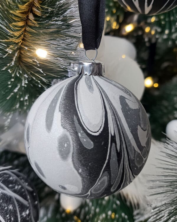 Monochrome marbled Christmas bauble decoration on Christmas tree