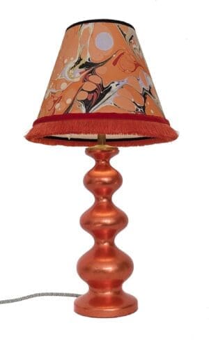 refininshed curvy lamp in orange silver leaf finish with marbled paper lampshade