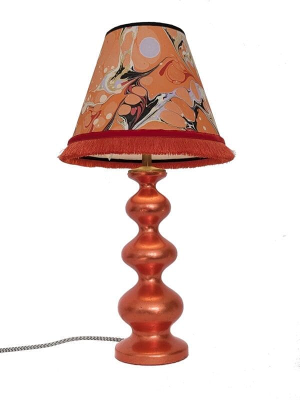 refininshed curvy lamp in orange silver leaf finish with marbled paper lampshade