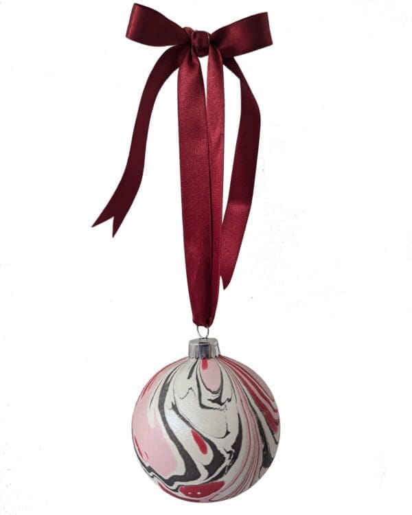 luxury Marbled Christmas bauble in red, pink, black and pearlescent white with red bow ribbon